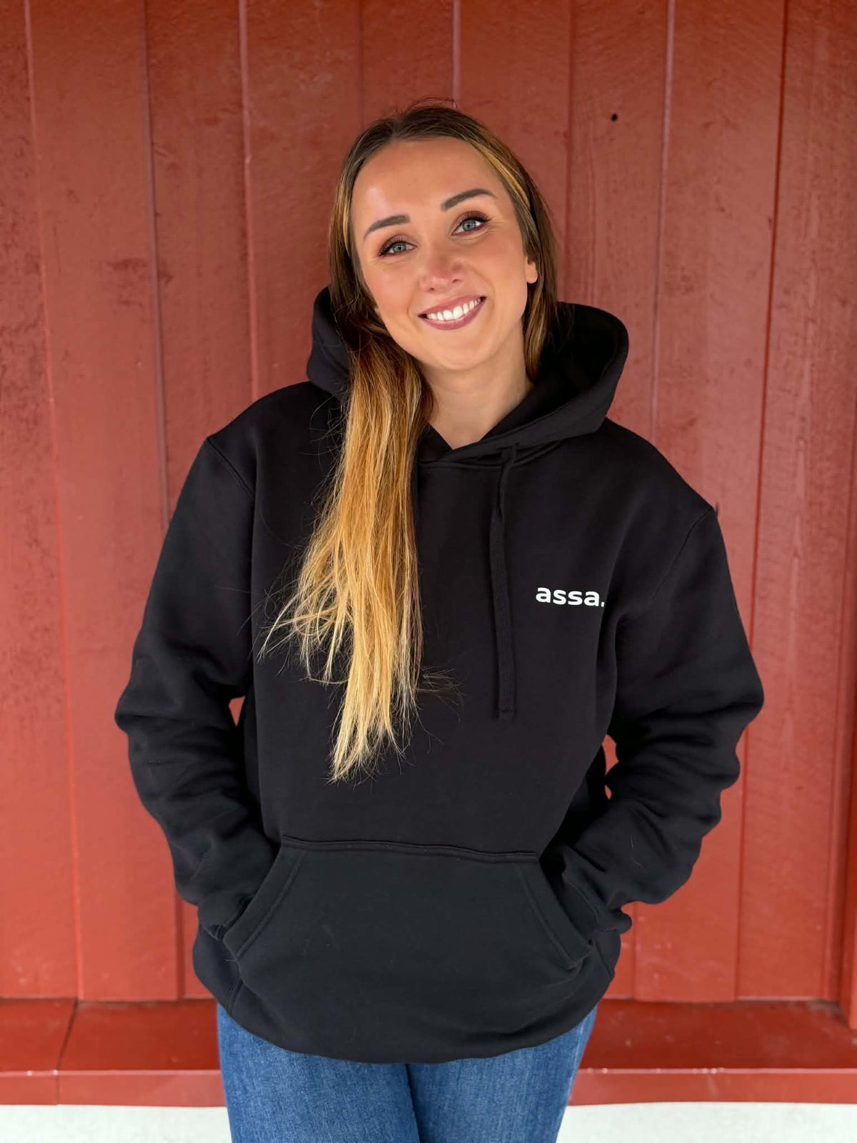Svart assa.-hoody med hvitt trykk, vist på modell