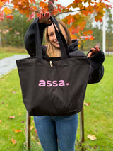 Svart assa.-handlenett med rosa glittertrykk, sett forfra